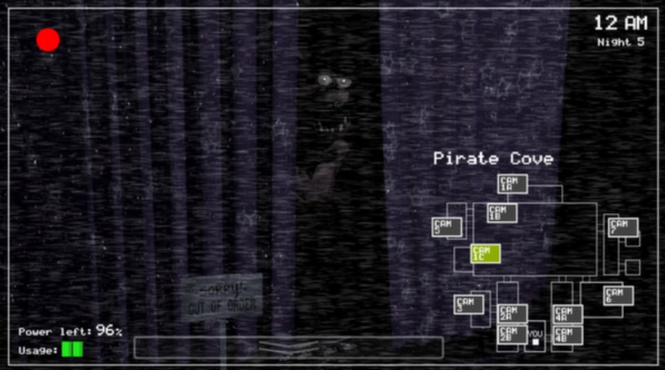 A screencap from the first fnaf game of Pirate Cove, with Foxy peeking his head out.