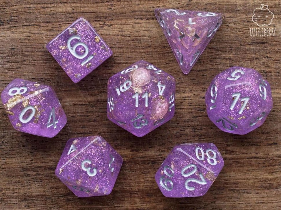 These are pink dice with a lot of glitter, and a bit of gold leaf inside. The numbers are white.