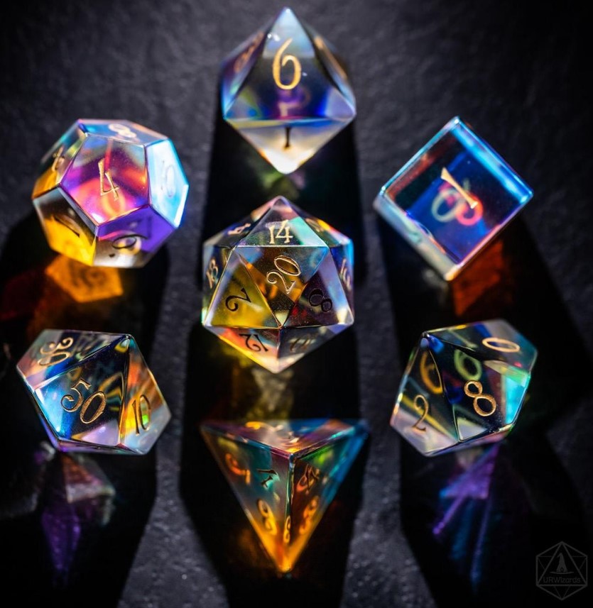 The dice are clear and colorful in the light, and have gold numbers painted on.