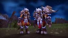 Two primitively clothed Tauren stand idly 
