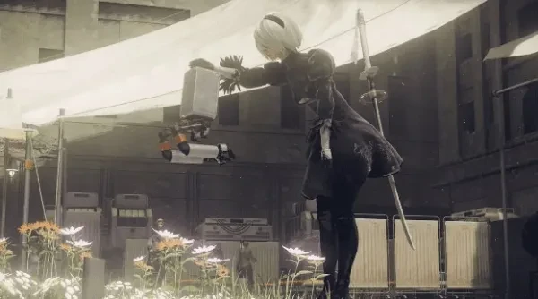 White haired woman bends over to pet flying robot.