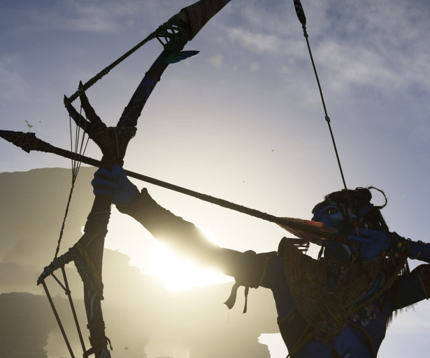 The silhouette of a Sarentu drawing their bow in front of a mountain and hazy sunset.