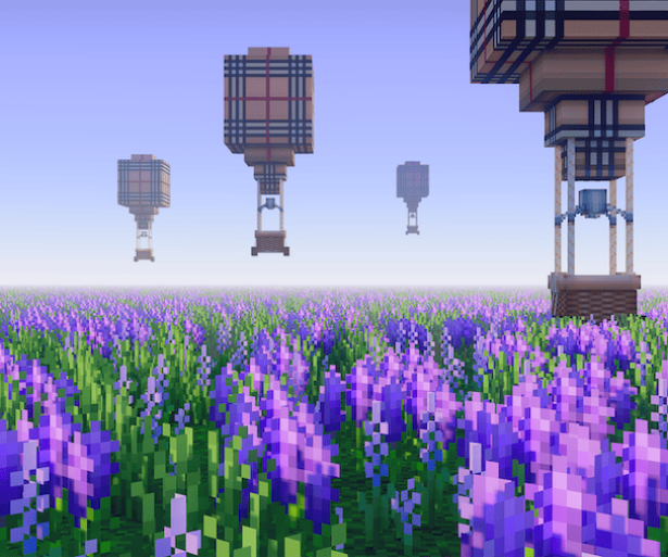 A beautiful image of a field of purple flowers and air balloons in the sky. 